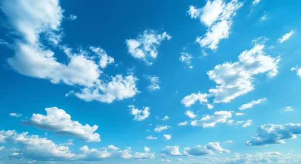 Wispy cirrus clouds stretching across a deep blue sky, evoking a sense of freedom and endless space.