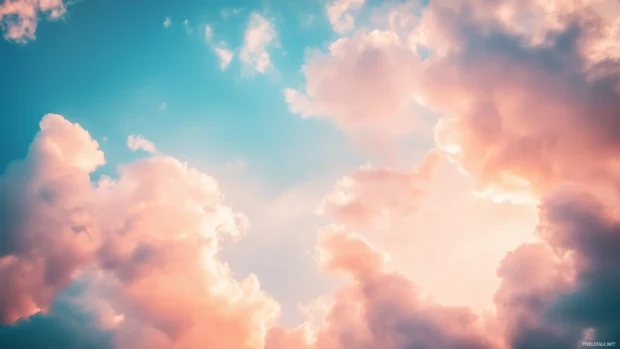 A dreamy sky filled with fluffy, cotton candy like pink clouds during a peaceful twilight.