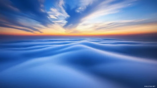 A mesmerizing view of a dense layer of fog and clouds blanketing a mountain range.