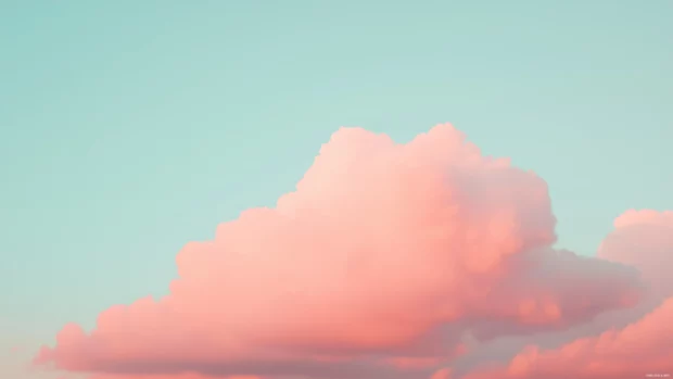 Aesthetic pink clouds drifting across a pastel sunset sky.