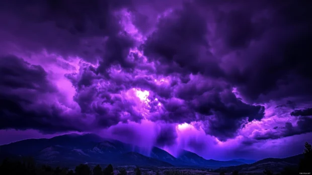 Dark purple storm clouds rolling in over a mountain range.