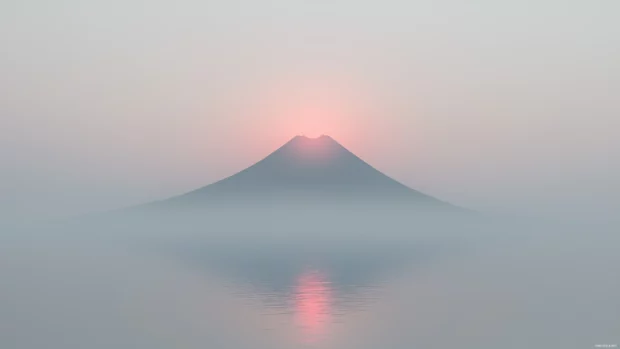 A simple desktop  HD wallpaper features a single mountain peak with a soft, misty atmosphere.