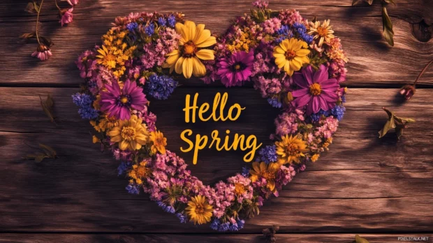 Beautiful Spring Desktop Wallpaper of wildflowers arranged in a heart shape on a rustic wooden background, with Hello Spring placed inside the heart in a stylish calligraphy font.