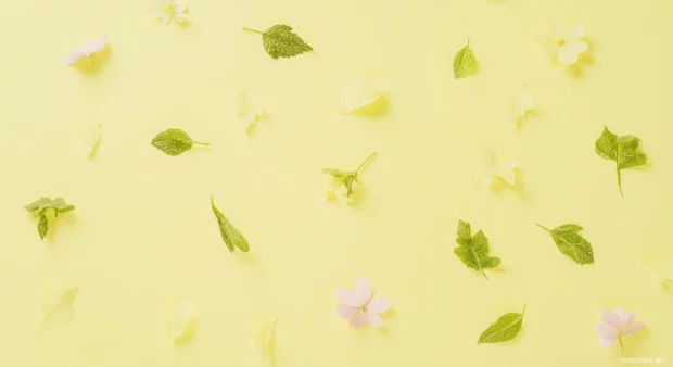 Preppy spring wallpaper with delicate leaves and flowers scattered across a pastel yellow background.