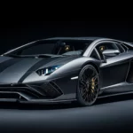 8K Car Wallpaper with a sleek black Lamborghini Aventador illuminated by soft spotlights, with subtle reflections enhancing its sharp angles and a pure black background.