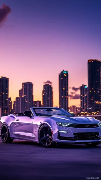 A 2022 Camaro SS Convertible parked in front of a modern city skyline at twilight.