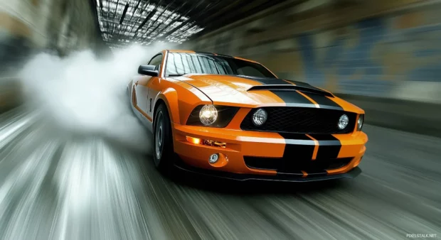 A Ford Mustang Shelby GT500 in fiery orange, drifting through a high speed corner with tire smoke and motion blur effects.