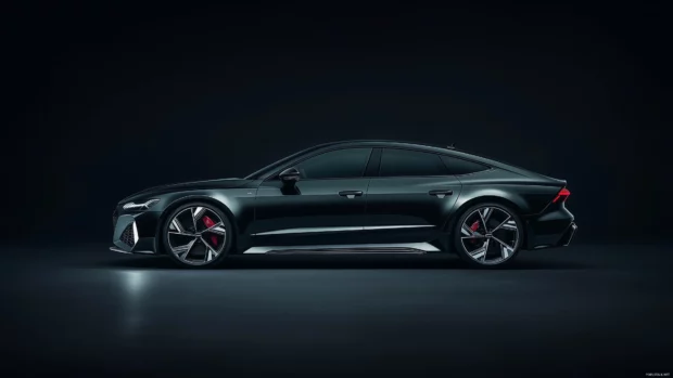 A black Audi RS7 in a minimalistic studio setting, with light reflecting off its contours, seamlessly blending into the black background.