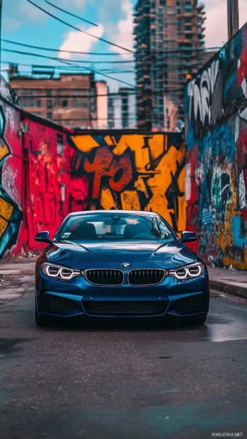 A blue BMW 4 Series coupe parked in an industrial area.