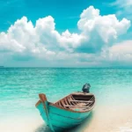 A dreamy tropical iPhonw wallpaper with soft pastel clouds, turquoise water.