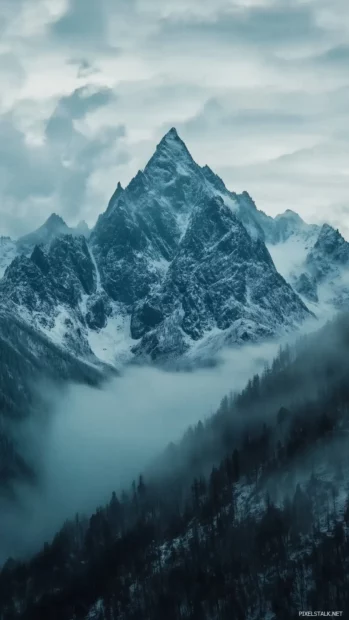 A serene blue mountain range in the distance with soft mist surrounding the peaks.