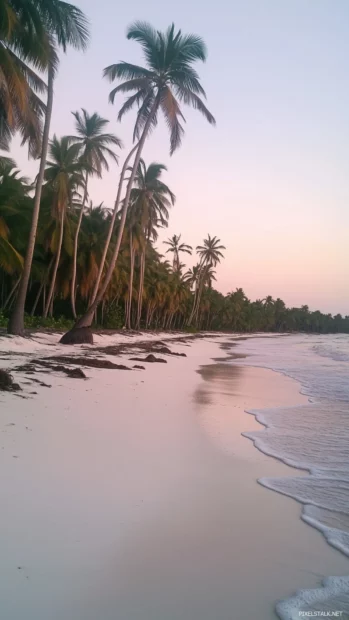 A serene tropical beach at sunset with soft pastel skies blending pink, orange, and purple hues, gentle waves lapping at the white sandy shore.