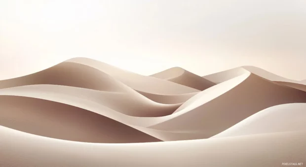 A simple wallpaper of a smooth sand beach with soft, flowing waves and a pale golden sky.