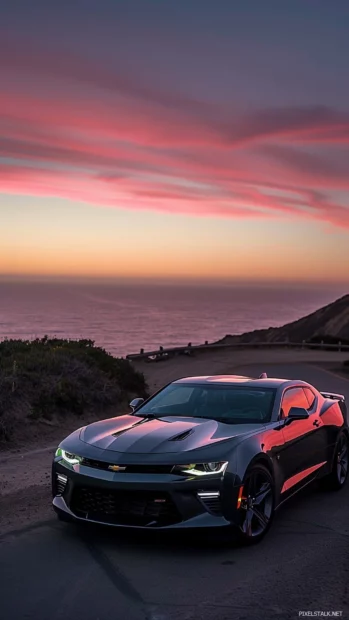 A sleek Camaro SS parked on a scenic coastal road at sunset.