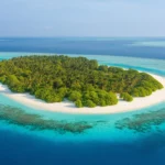 A stunning aerial view of a secluded tropical beach on a remote island.