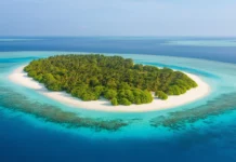 A stunning aerial view of a secluded tropical beach on a remote island.