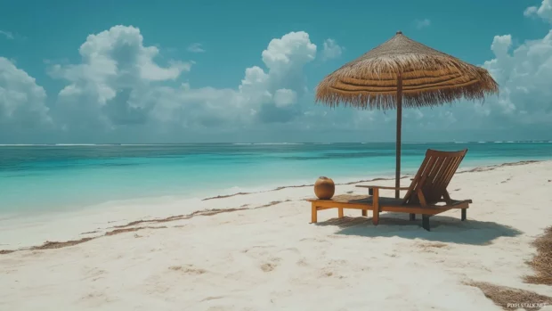 A tropical beach scene with a wooden beach chair, straw umbrella, and a fresh coconut drink on the side.