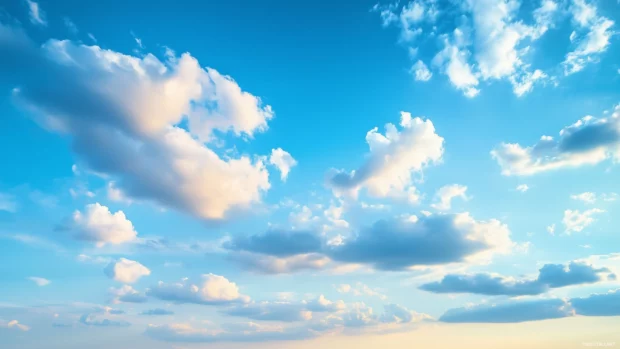 A vast sky filled with soft, billowing blue clouds drifting peacefully.