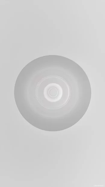 A very light gray background 4K with a soft, glowing circle at the center.