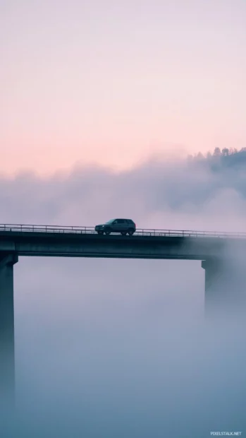 An aesthetic car silhouette emerging from soft fog on a modern bridge.