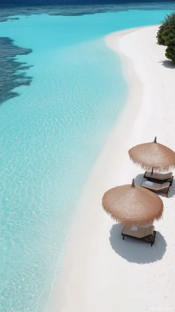 An overhead view of a pristine tropical beach with white sand and clear aqua water, soft waves creating subtle patterns on the sand.