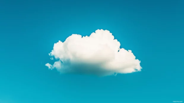 Bright white clouds floating against a clear, vibrant blue sky.