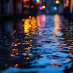 Rain falling on a calm city canal at dusk, water reflecting colorful lights from nearby buildings and streetlamps, ripples gently spreading across the surface.