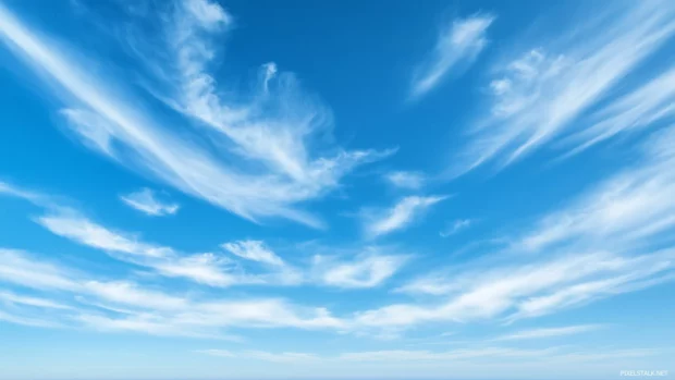 Wispy cirrus clouds stretching across a deep blue sky.