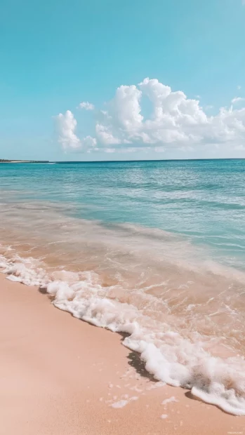 A beach with gentle ripples in the sand wallpaper.