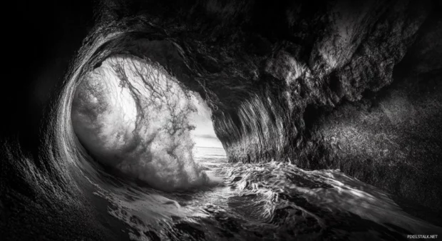 A black and white photograph of a wave crashing on the shore at Miami Beach wallpaper.