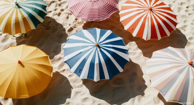 A collage wallpaper of beach umbrellas with colorful patterns.