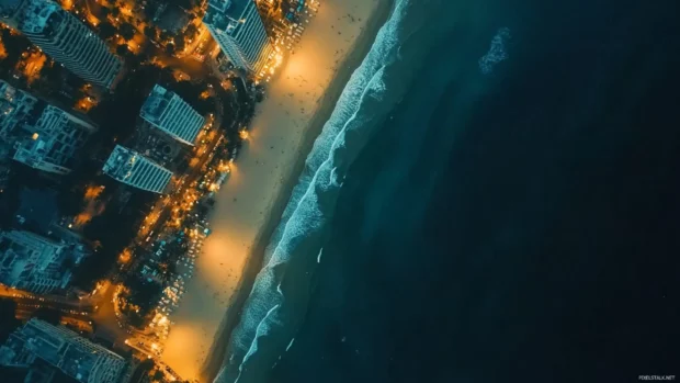 A drone shot of a dark beach at night .