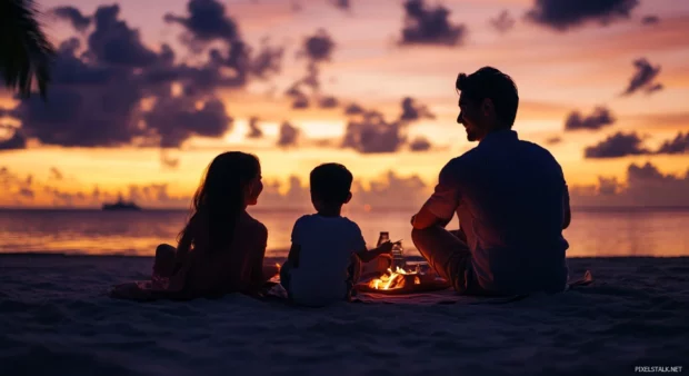 A family enjoying a picnic on the beach at sunrise wallpaper.