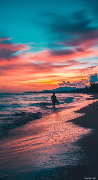 A silhouette of a surfer against a vibrant sunset sky beachy wallpaper.