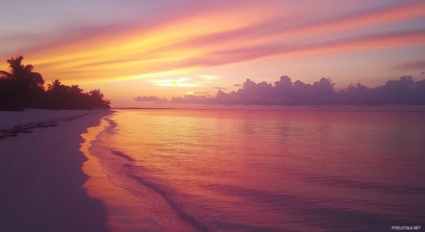 A stunning sunset over a Bahamas beach wallpaper.