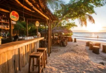 A wallpaper of beachside bar overlooking the ocean as the sun rises .