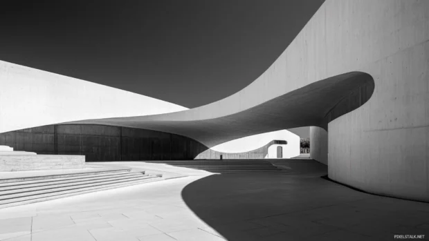 Sunlight casts shadows along clean architectural lines in grayscale.