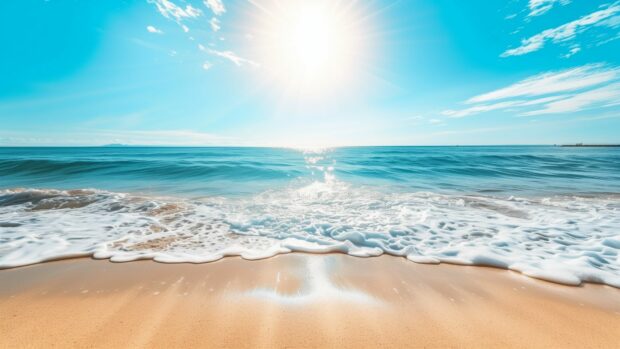 A bright sunny day over a beach with gentle waves lapping the shore.