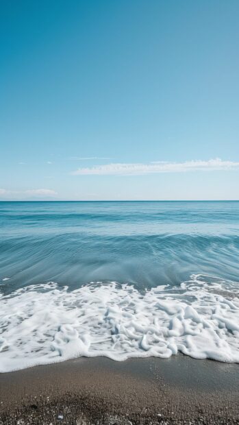 A calm ocean background with a bright blue sky and gentle waves.