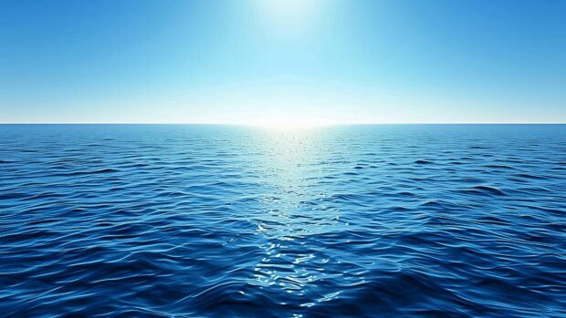 A calm ocean with a gentle breeze and small waves under a clear sky, ocean 4K background.