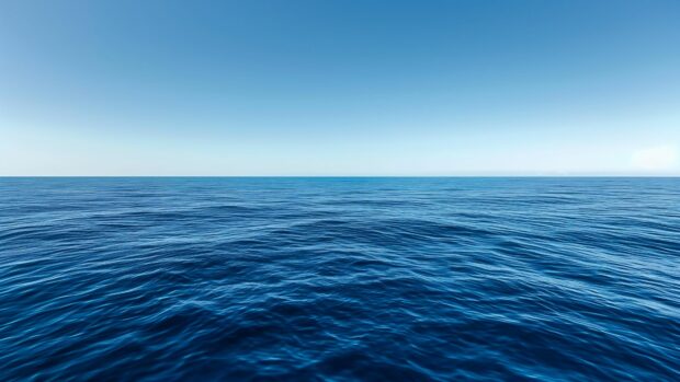 A deep blue ocean wallpaper 4K stretching out to the distant horizon under a clear sky.