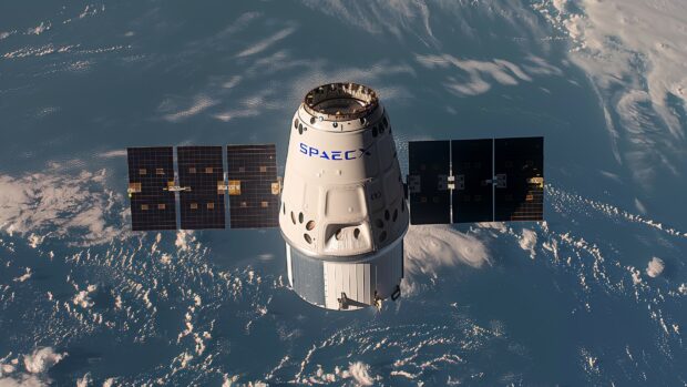 A serene image of the SpaceX Dragon capsule orbiting Earth, with the planets blue oceans and white clouds in the background.