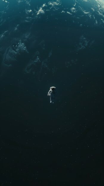 An astronaut floating in space HD wallpaper for iPhone with Earth in the background, capturing the vastness of space.