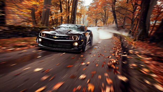 Camaro roaring through a forest road with autumn leaves scattered around.