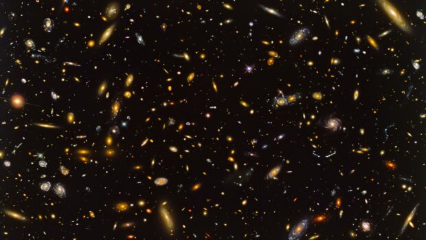 Cool Outer Space background with a panoramic view of a distant galaxy cluster, with multiple galaxies visible against the blackness of space.