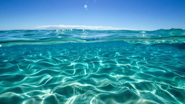 Free download Ocean background with a calm ocean with crystal clear turquoise water and a clear blue sky.