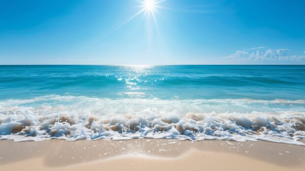 HD Desktop Wallpaper with a bright sunny day over a clear blue ocean with gentle waves.