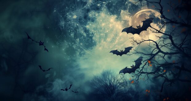 Halloween Wallpaper 4K with moonlit night with bats flying across the sky.