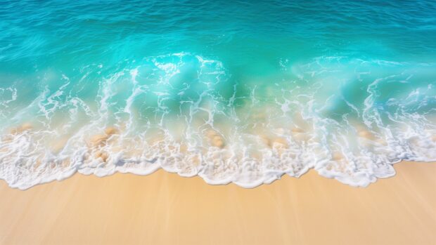 Ocean Waves desktop wallpaper with aerial view of turquoise ocean waves rolling towards a sandy beach.