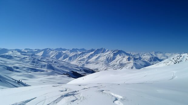 Snow covered mountains under a clear blue sky, pristine white slopes 4, Nature picture.